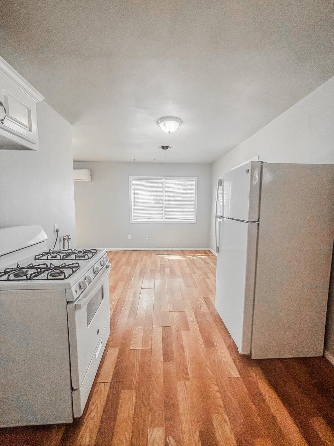 505 East 37th Street Lubbock, TX 79404 - Photo 9 of 25 a view of a kitchen with a white stove top oven and refrigerator