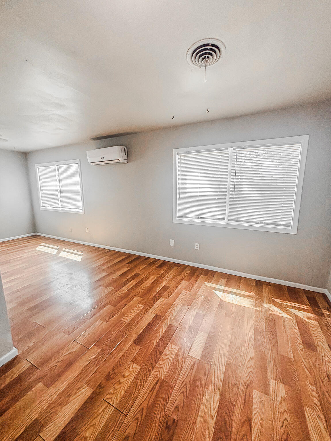 505 East 37th Street Lubbock, TX 79404 - Photo 10 of 25 an empty room with wooden floor and windows