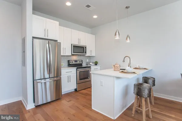 a kitchen with a refrigerator a sink and a stove