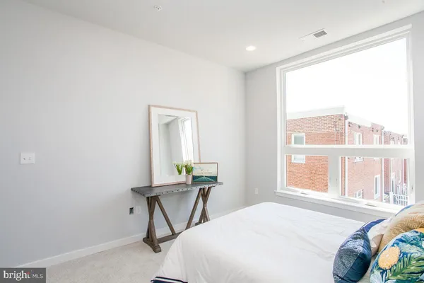 a bedroom with a bed and a window