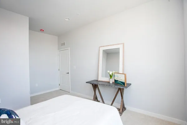 a bedroom with a bed and a mirror