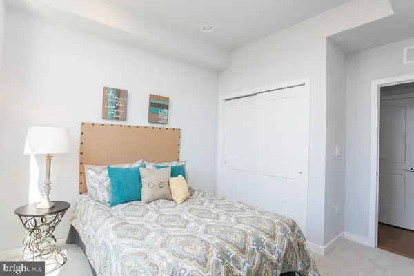 a bedroom with a bed and a lamp