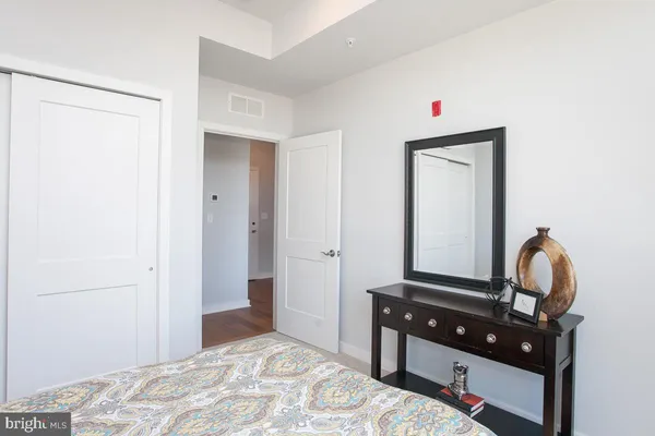 a bedroom with a bed and a dresser