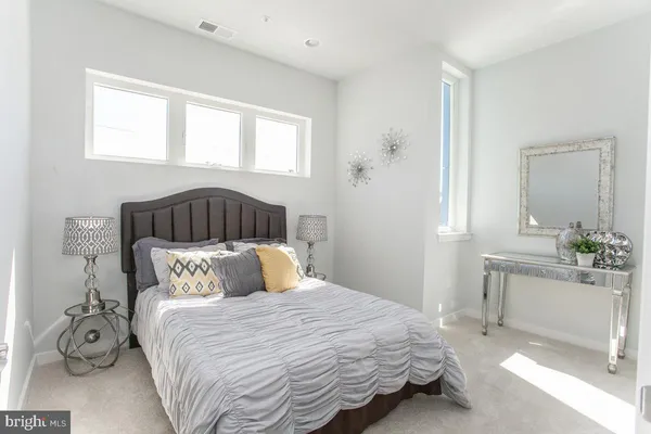 a bedroom with a bed and window