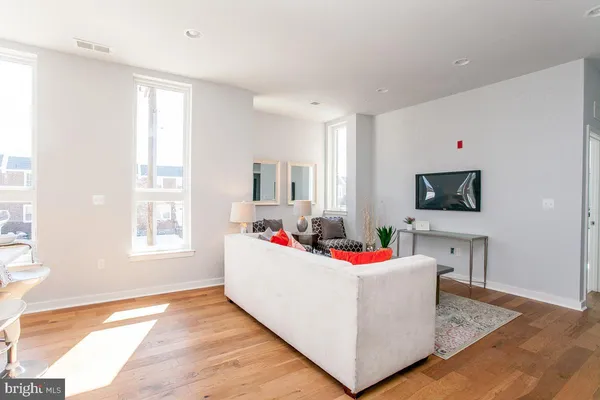 a living room with dining room and flat screen tv