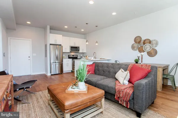 a living room with furniture and kitchen view