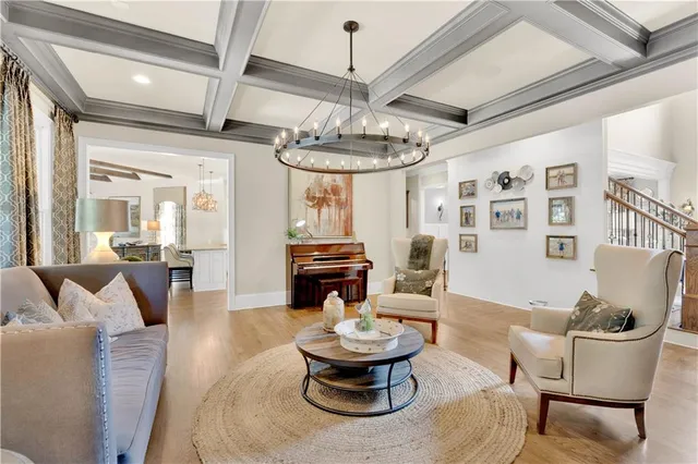 a living room with furniture a flat screen tv and a large window