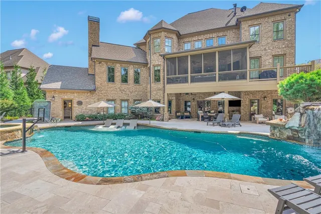 a view of a patio with table and chairs potted plants and large tree
