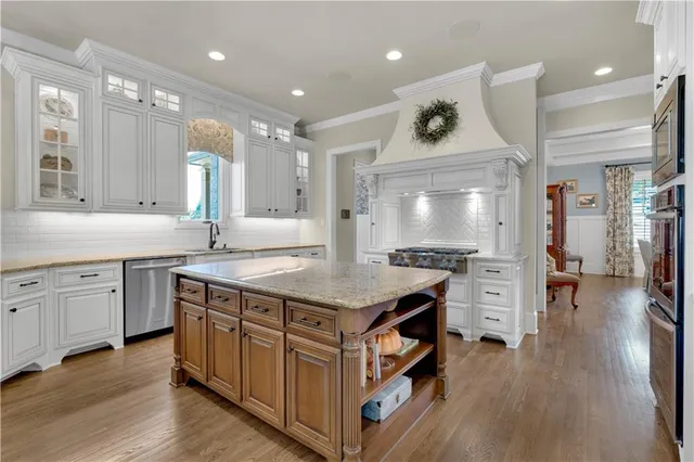 a bathroom with a granite countertop sink toilet and mirror