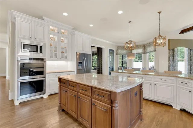 a spacious bedroom with a bed and a chandelier