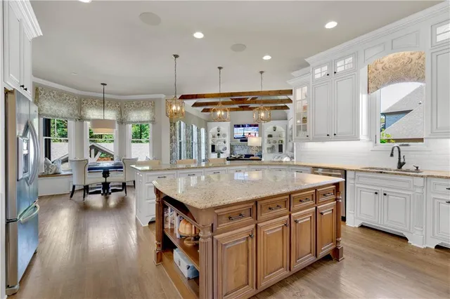 a spacious bedroom with a bed and a chandelier