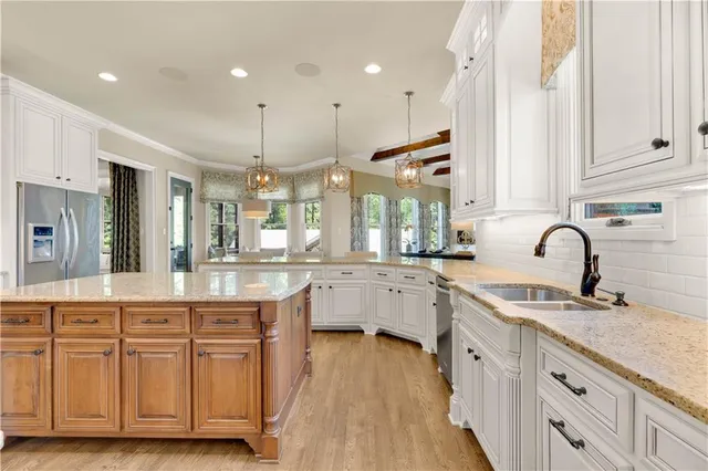 a bedroom with bed and a flat tv screen on dresser
