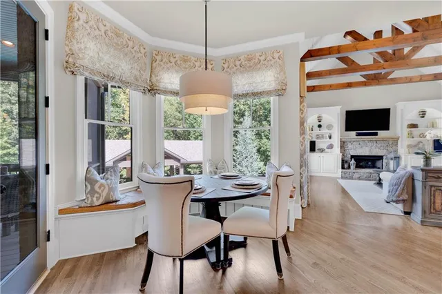 a spacious en suite bathroom with a tub double sink and mirror