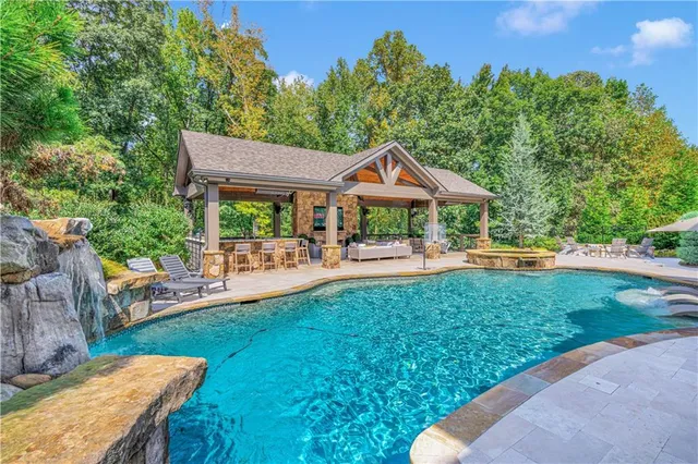 a view of a house with swimming pool and porch