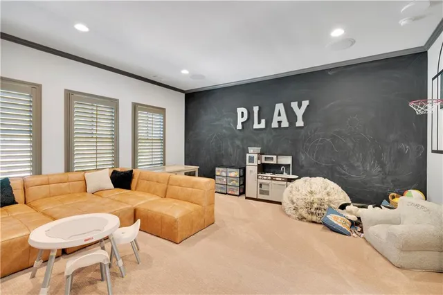 a living room with furniture a dining table and a chandelier
