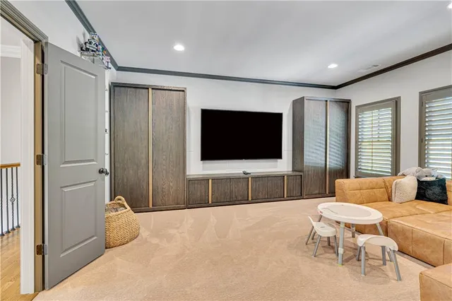a view of a brick house with many windows next to a yard