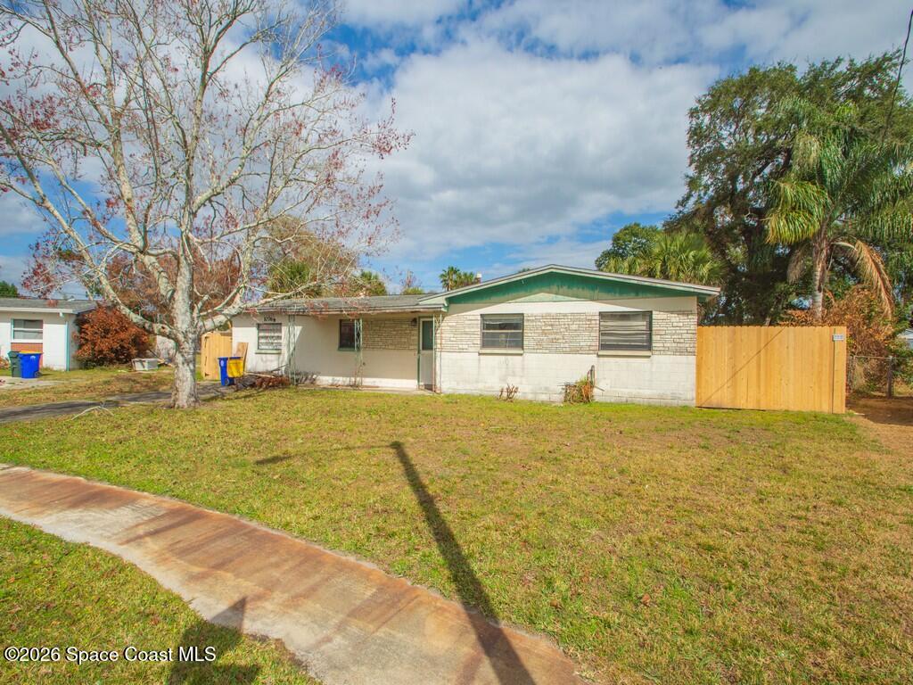 1076 Madrid Road Rockledge, FL 32955 - Photo 1 of 30 a front view of house with yard and trees