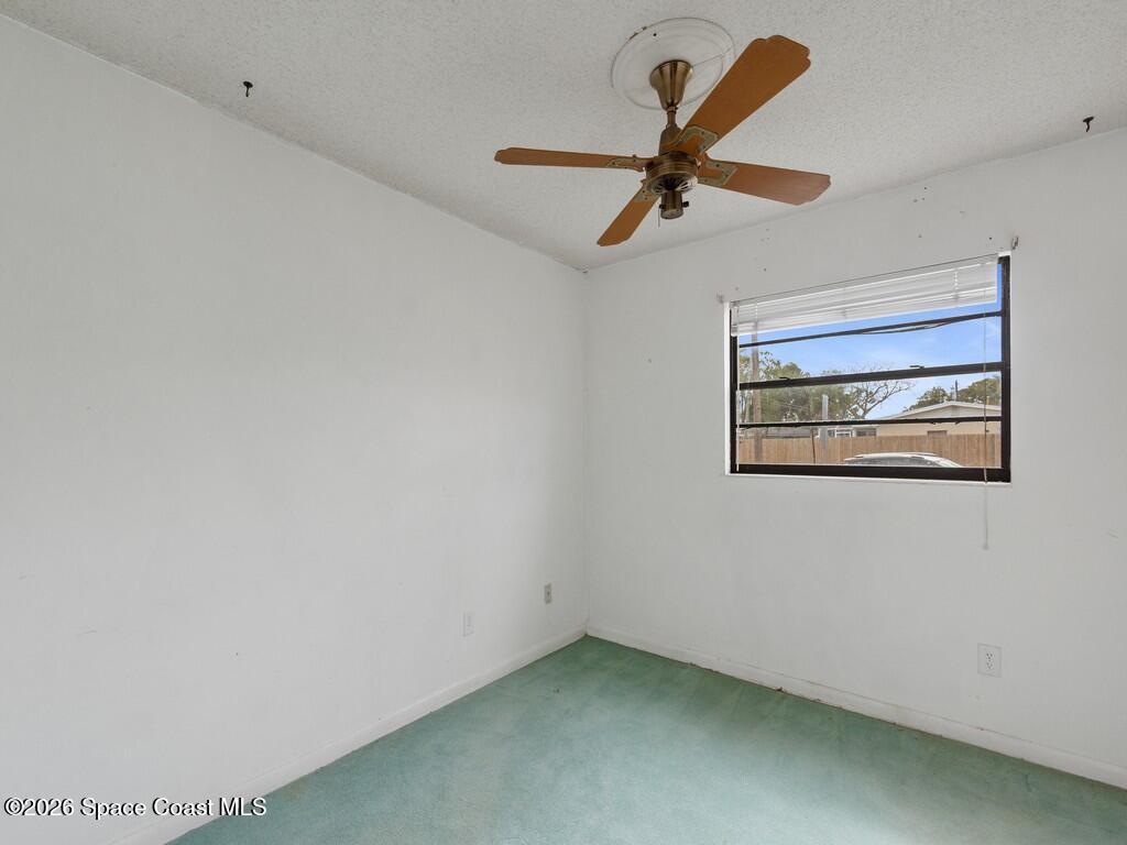 1076 Madrid Road Rockledge, FL 32955 - Photo 15 of 30 a view of a ceiling fan with a ceiling fan