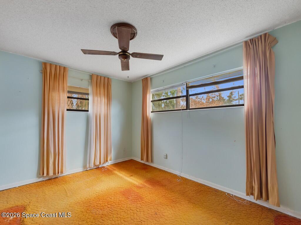 1076 Madrid Road Rockledge, FL 32955 - Photo 18 of 30 a view of empty room with windows