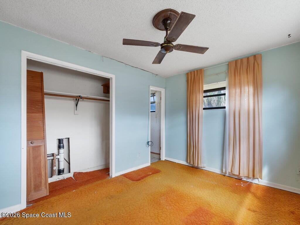 1076 Madrid Road Rockledge, FL 32955 - Photo 19 of 30 a view of a room with a ceiling fan