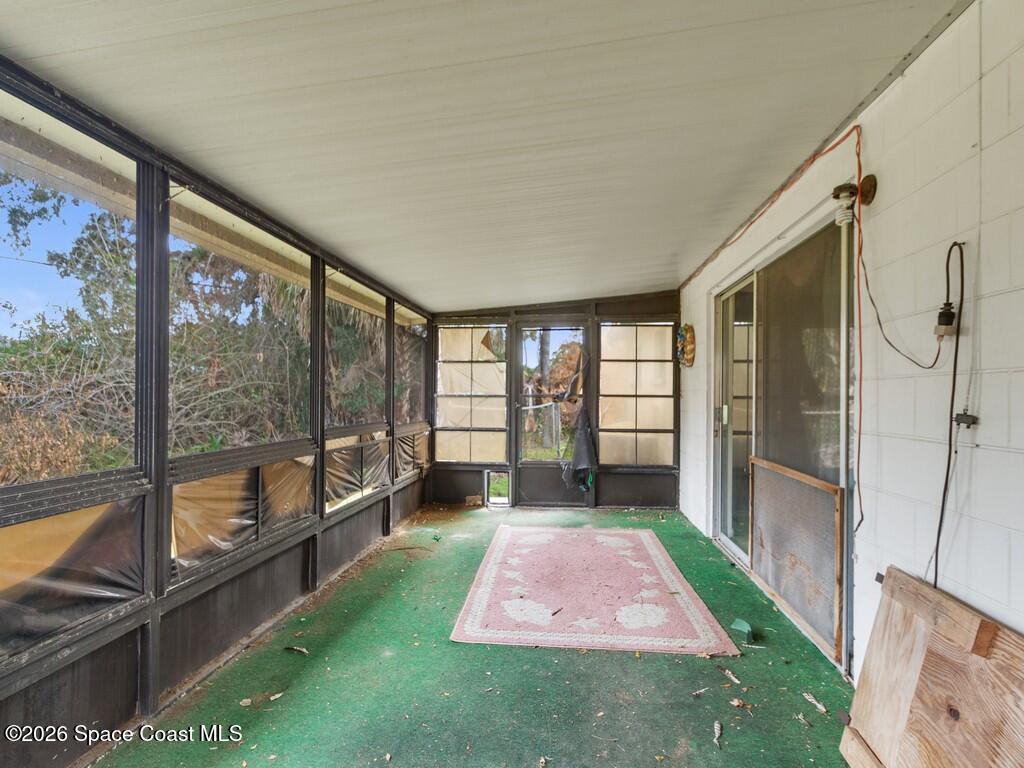 1076 Madrid Road Rockledge, FL 32955 - Photo 21 of 30 a hallway with a view of outdoor space