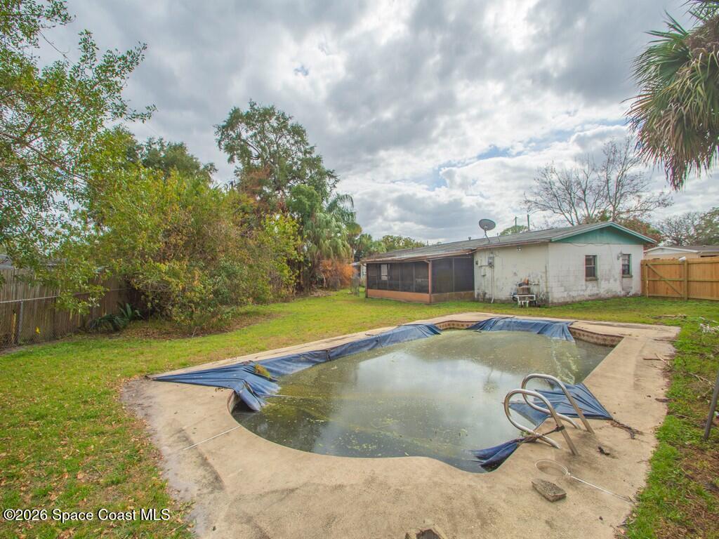1076 Madrid Road Rockledge, FL 32955 - Photo 26 of 30 a view of a house with swimming pool and a yard