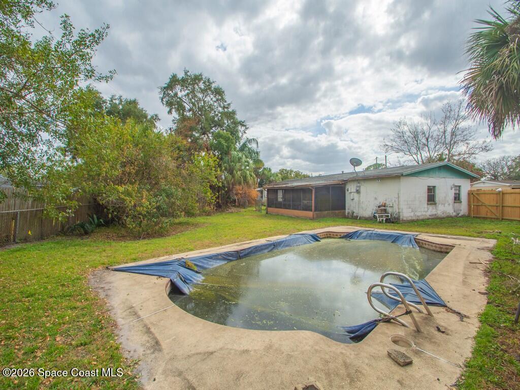 1076 Madrid Road Rockledge, FL 32955 - Photo 27 of 30 a view of a house with swimming pool and a yard