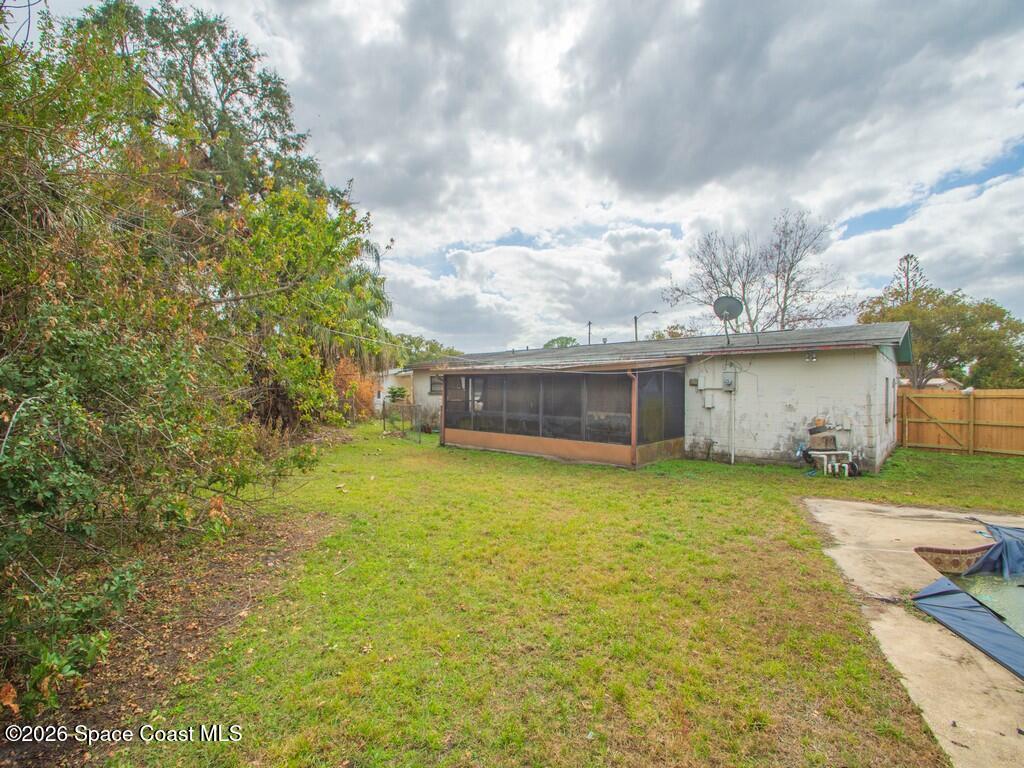 1076 Madrid Road Rockledge, FL 32955 - Photo 28 of 30 a front view of a house with a yard
