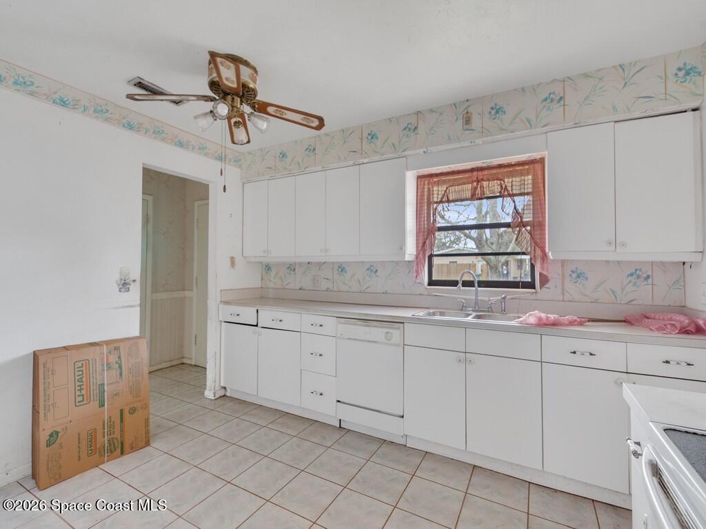1076 Madrid Road Rockledge, FL 32955 - Photo 4 of 30 a kitchen with sink cabinets and window