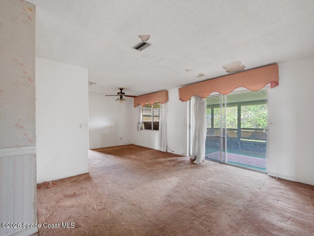 1076 Madrid Road Rockledge, FL 32955 - Photo 7 of 30 an empty room with windows