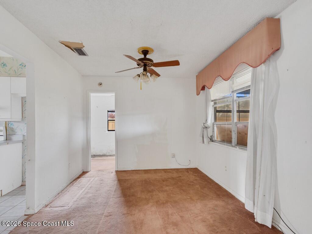 1076 Madrid Road Rockledge, FL 32955 - Photo 9 of 30 a view of empty room with a ceiling fan