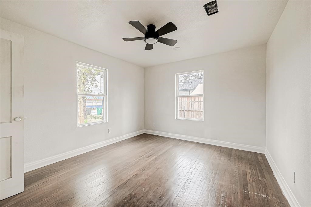 7010 South Hall Street Houston, TX 77028 - Photo 24 of 33 an empty room with wooden floor fan and windows