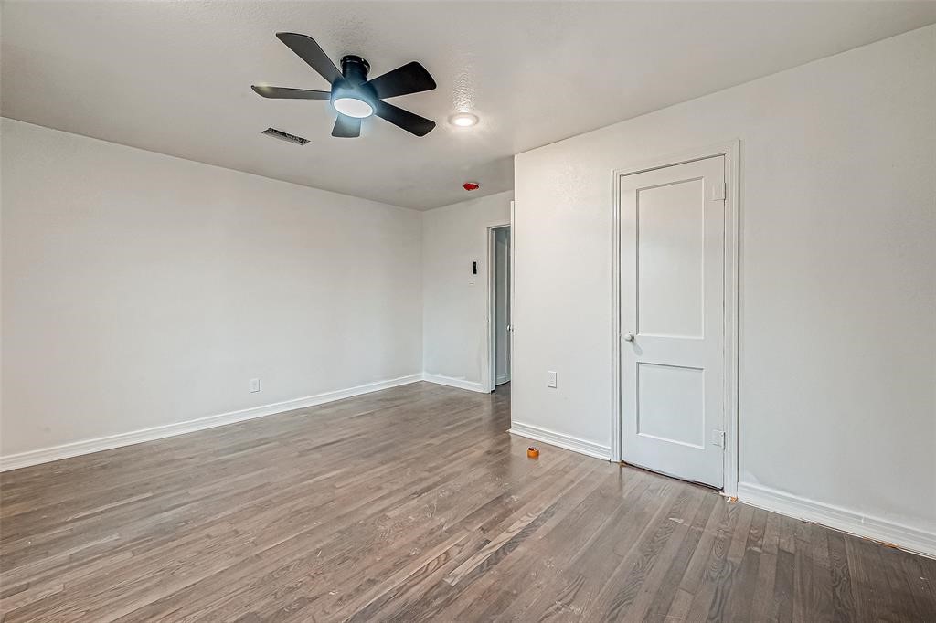 7010 South Hall Street Houston, TX 77028 - Photo 29 of 33 an empty room with wooden floor chandelier fan and windows