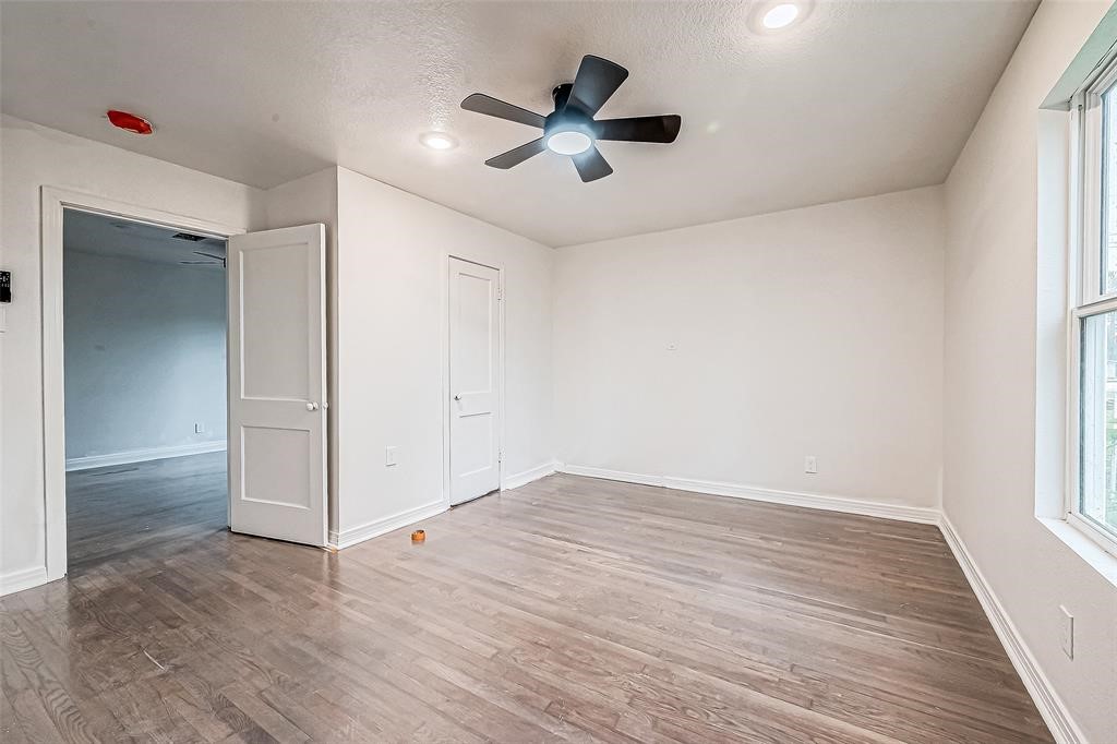 7010 South Hall Street Houston, TX 77028 - Photo 30 of 33 wooden floor in an empty room with a window