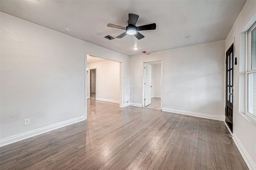 7010 South Hall Street Houston, TX 77028 - Photo 7 of 33 wooden floor in an empty room with a window