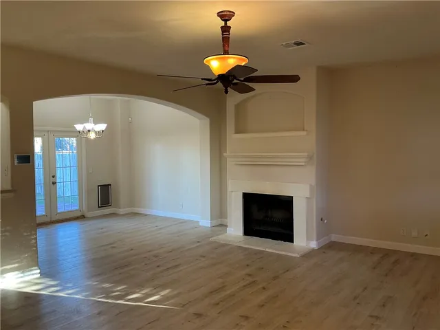 a living room with a fireplace and a chandelier