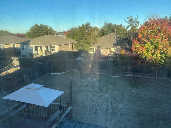 a backyard of a house with table and chairs