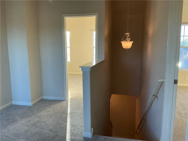 an empty room with windows and cabinet