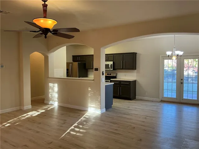 a kitchen with stainless steel appliances granite countertop a refrigerator and a stove top oven