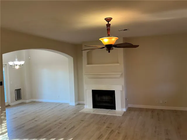 a view of empty room with a fireplace