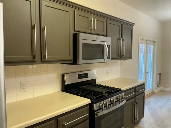 a kitchen with stainless steel appliances a stove a microwave and cabinets