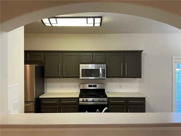 a kitchen with a refrigerator and a stove