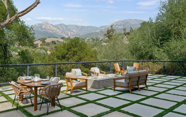 a balcony with table and chairs