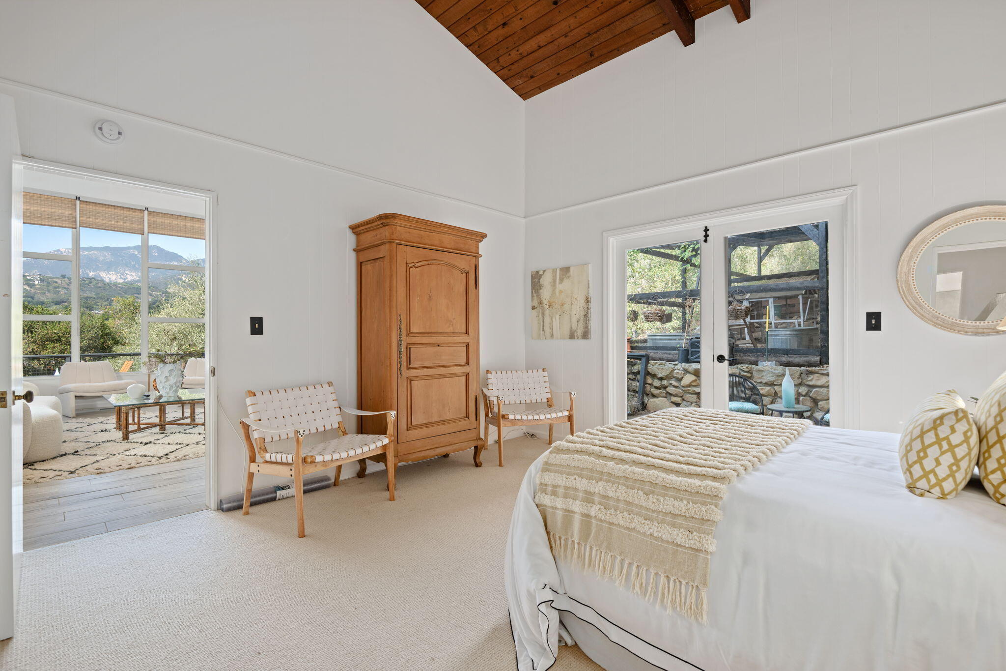 2253 Las Canoas Road Santa Barbara, CA 93105 - Photo 26 of 53 a bedroom with a bed a table and large windows
