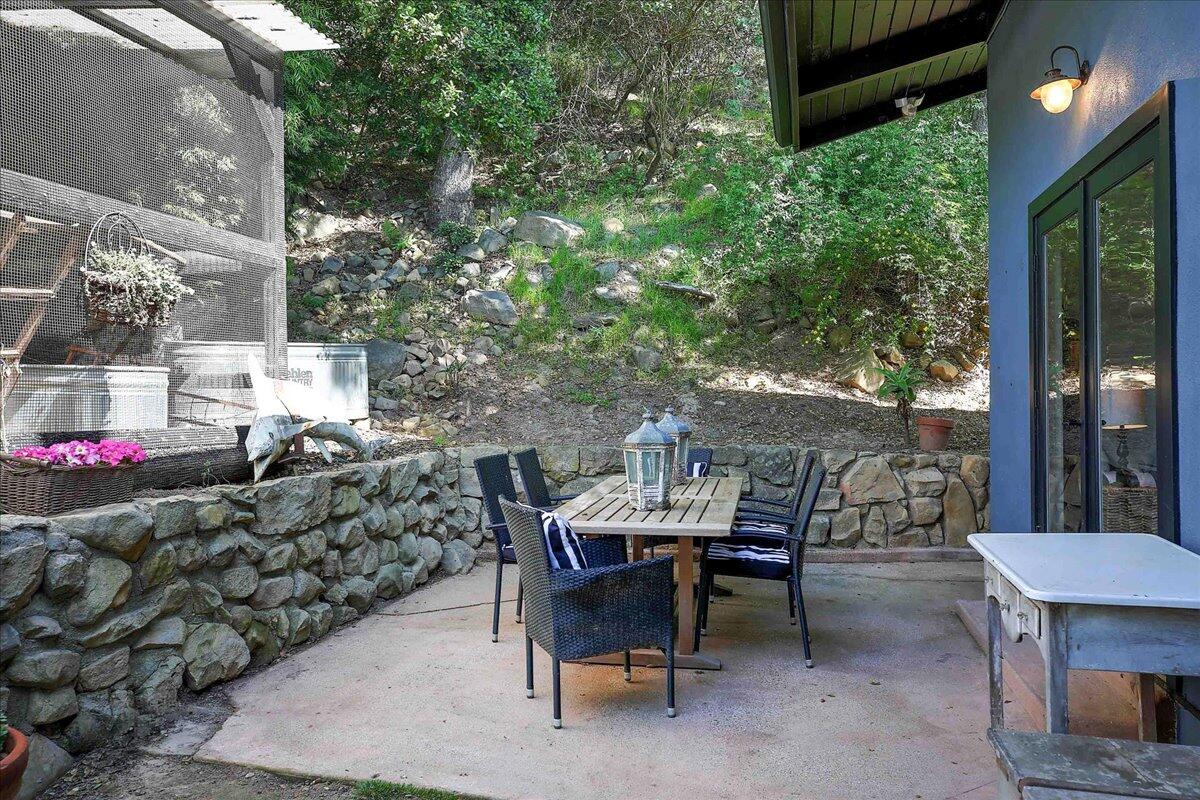 2253 Las Canoas Road Santa Barbara, CA 93105 - Photo 28 of 53 a view of a patio with table and chairs and potted plants