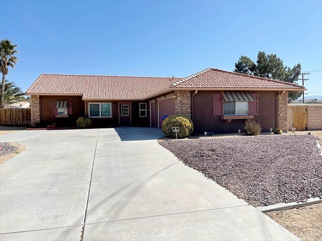 12915 Choco Road Apple Valley, CA 92308 - Photo 1 of 1 a front view of a house with a yard