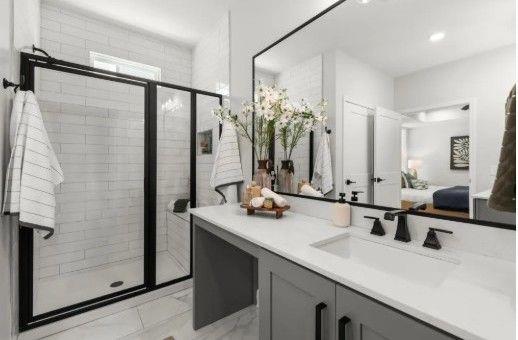 220 Gabriel Boulevard Woodstock, GA 30188 - Photo 7 of 8 a bathroom with a double vanity sink a mirror and shower