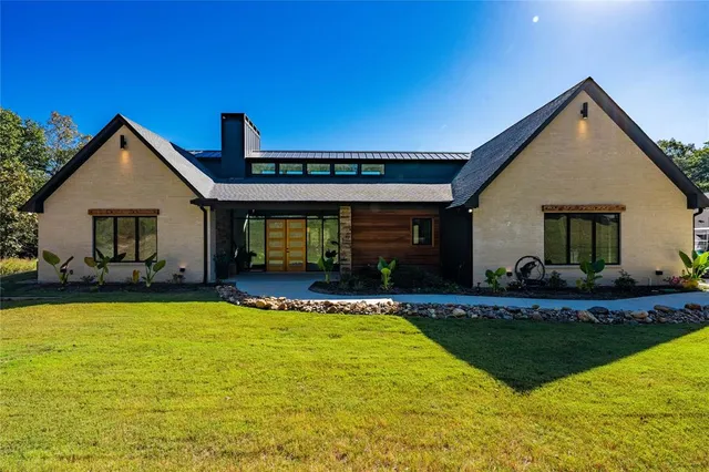 a view of a house with swimming pool and a yard