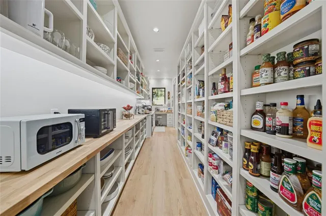 a hallway with washer and lots of wooden cabinets