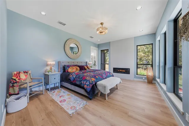 a bedroom with a bed and a chandelier